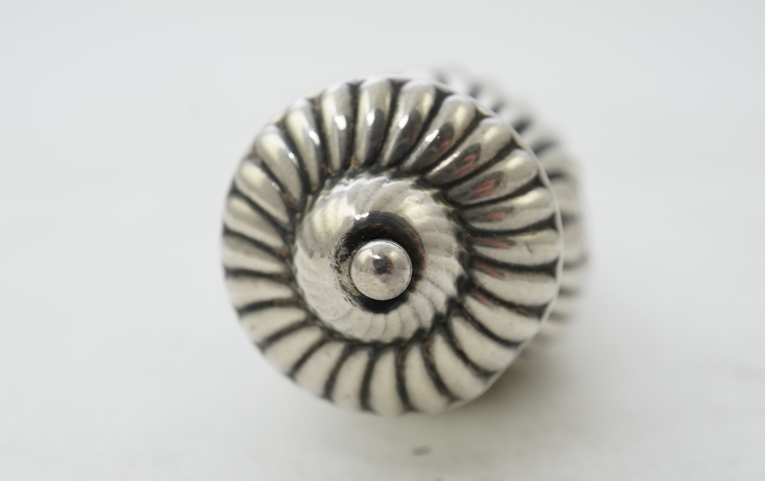 A late Victorian silver scent flask, of spiral tear drop form, with hinged cover and glass stopper